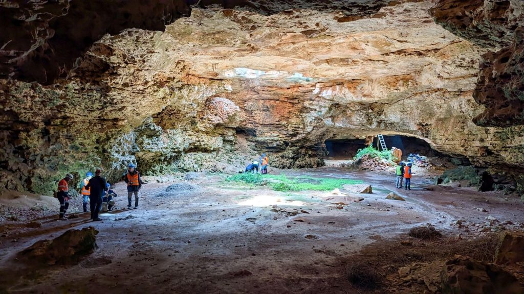 Waterhouse Club expeditioners surveying a Nullarbor cave